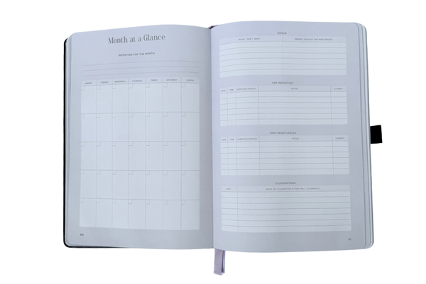 Open planner with monthly layout on a white background